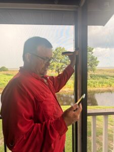 Haynes technician checking a window frame with termite detection equipment