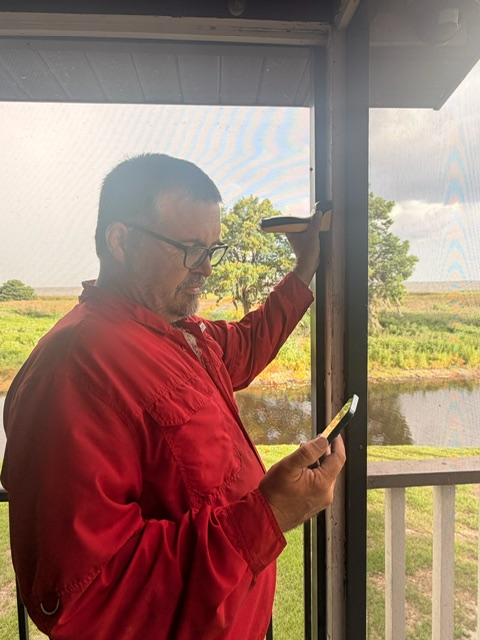 Haynes technician checking a window frame with termite detection equipment